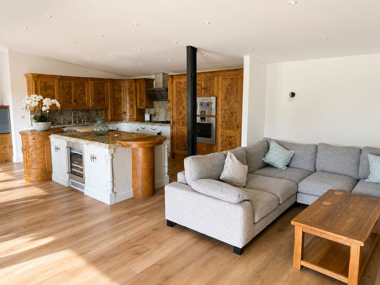 Open-plan kitchen and living area with a large sofa
